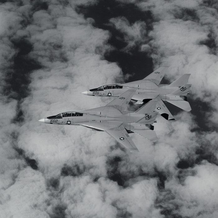 An air-to-air left side view of two F-14 Tomcat aircraft An air-to-air left side view of two F-14 Tomcat aircraft
