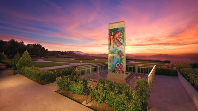A piece of the Berlin Wall at sunset A piece of the Berlin Wall at sunset