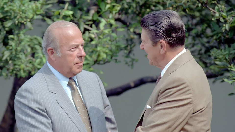 60th Secretary of State George Shultz shaking hands with Ronald Reagan.
