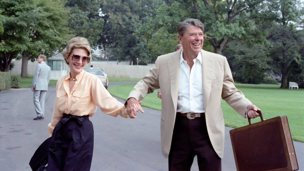 Nancy and Ronnie laughing and holding hands
