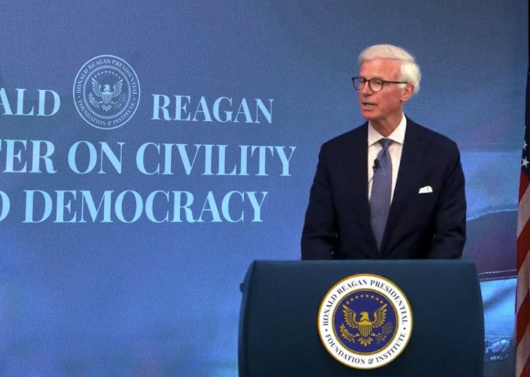 Fred Ryan speaking at a podium