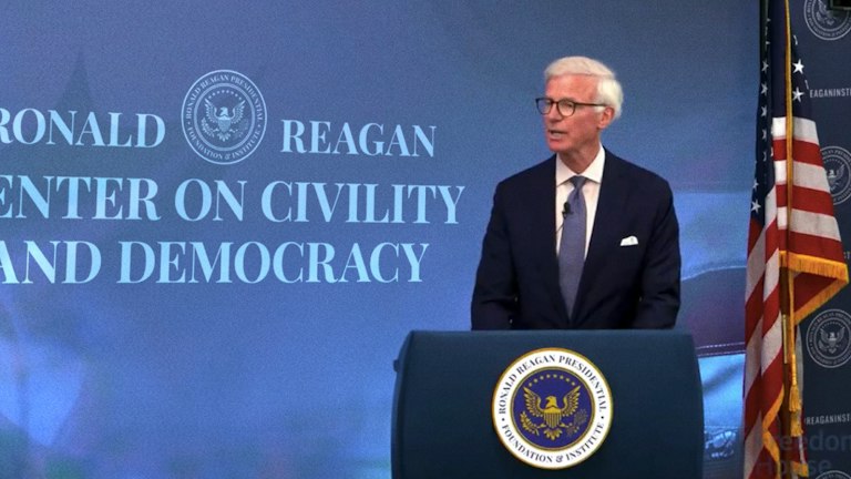 Fred Ryan speaking at a podium