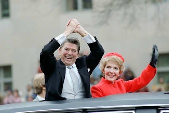 Ronald and Nancy Reagan waving from car Ronald and Nancy Reagan waving from car