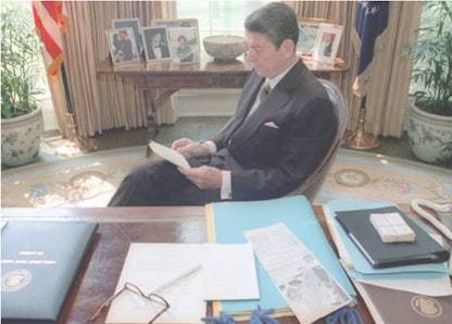 Reagan reading in oval office Reagan reading in oval office