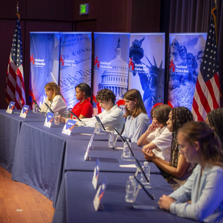 Students competing in the National Civics Bee Students at event tables