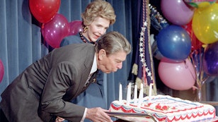 President Reagan blowing out candles on his birthday cake President Reagan blowing out candles on his birthday cake while Nancy Reagan looks on at a surprise 76th birthday party