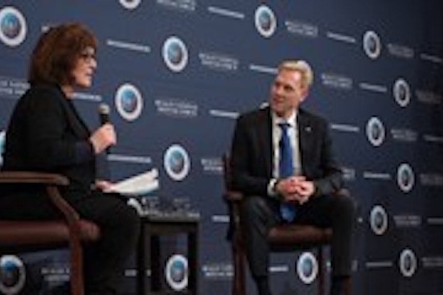 Man and woman speaking on stage