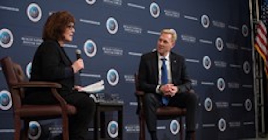Man and woman speaking on stage