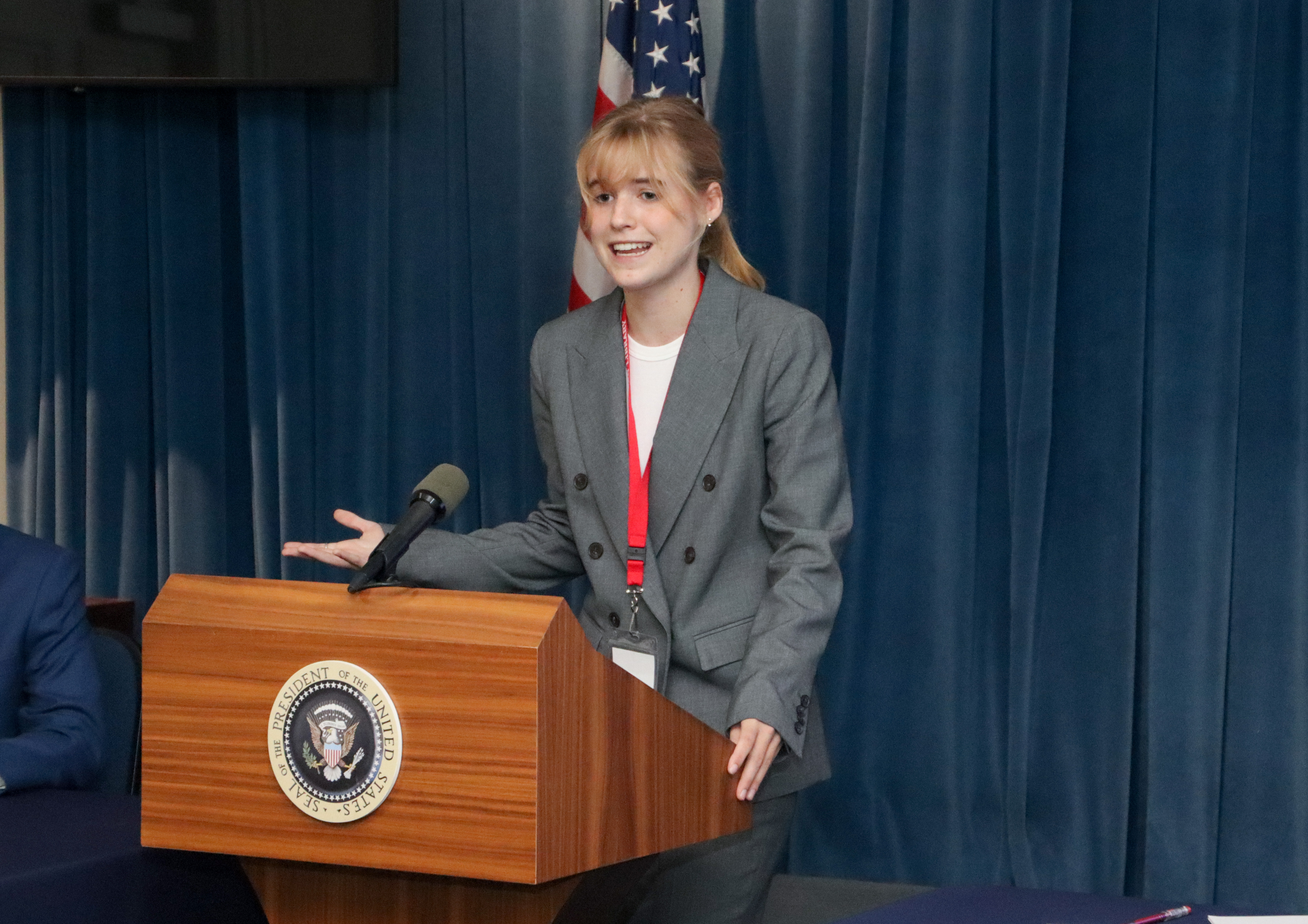Female Student at Presidential Podium
