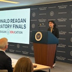 2024 Oratory Finalist Female Student at Presidential Podium with Judges