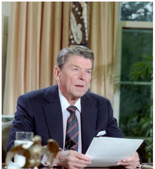 President Reagan at his desk in Oval Office