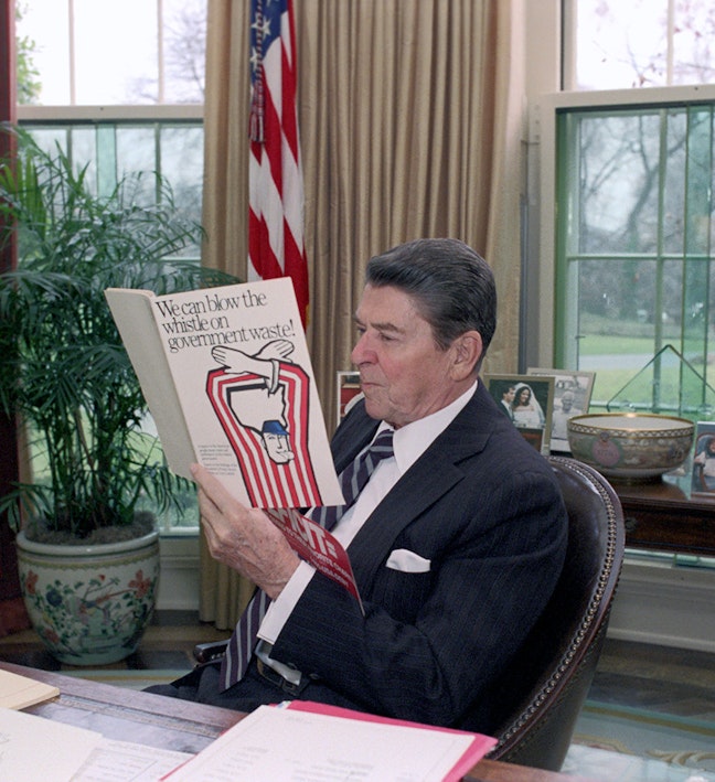 President Reagan reads "We can blow the whistle on government waste" President Reagan sitting in the oval office reading a pamphlet