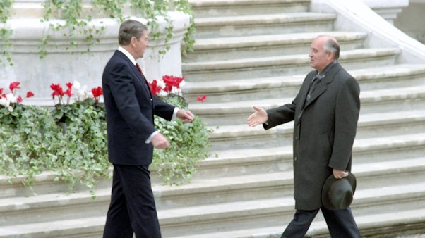 Arrival of General Secretary Mikhail Gorbachev of the Soviet Union for his first meeting with President Reagan for the Geneva Summit at Fleur D’Eau in Switzerland. 11/19/1985. Two men in suits and jackets approach each other for a handshake