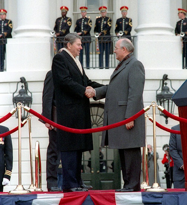President Reagan and Soviet General Secretary Gorbachev shaking hands at the arrival ceremony on the White House south lawn. 12/08/1987. Two men shake hands outside of the white house