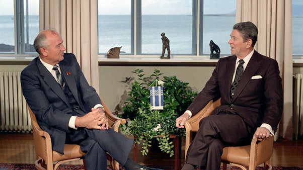 C37406-14, President Reagan meeting with Soviet General Secretary Gorbachev at Hofdi House during the Reykjavik Summit. Iceland. 10/11/1986. Two men sit talking with a view of the ocean in the background