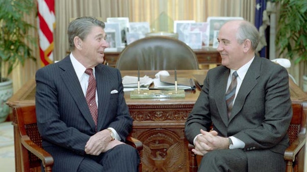 President Reagan and Soviet General Secretary Gorbachev at a morning meeting in the Oval Office during the Washington Summit. 120/9/1987. Two men talking in suits in the oval office