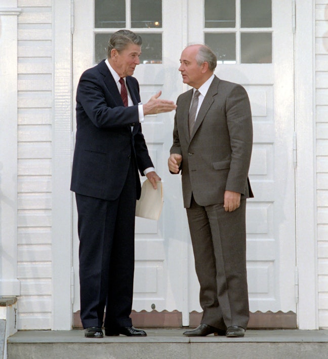 President Reagan greets Soviet General Secretary Gorbachev at Hofdi House during the Reykjavik Summit. Iceland. 10/12/1986. Two men talking in suits outside of a white building