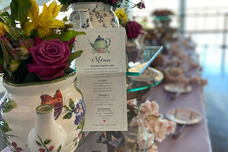 Floral tea kettle vase with roses.
