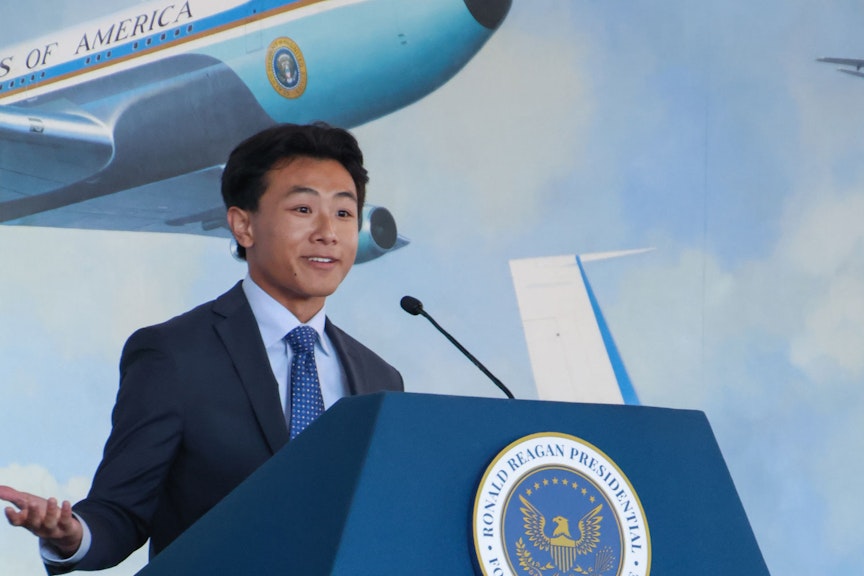 Debator stands in front of a podium
