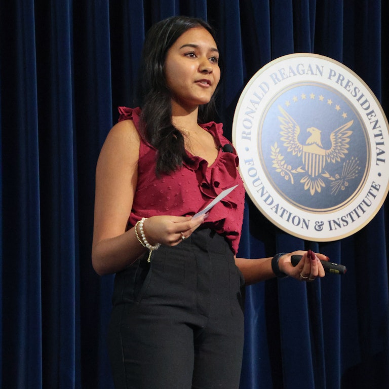 Female Student Conference Image Female Student Speaking on stage
