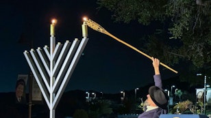 Person lighting the Menorah