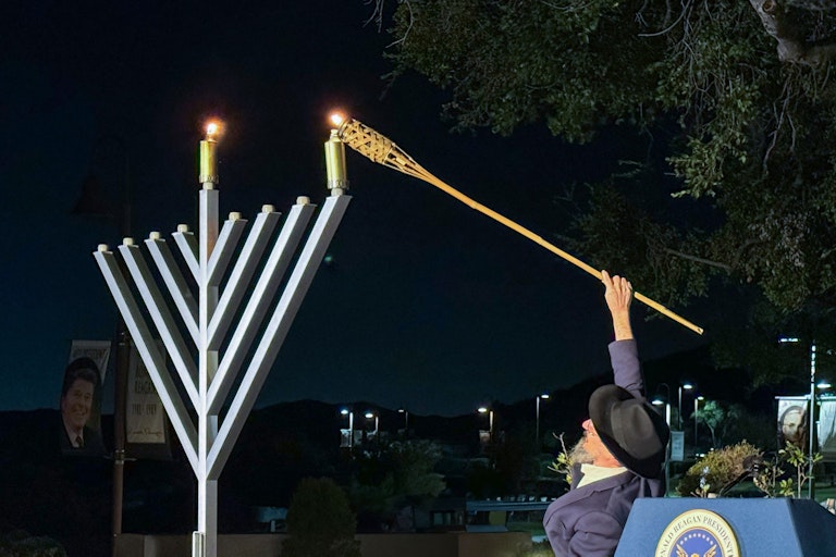 Person lighting the Menorah