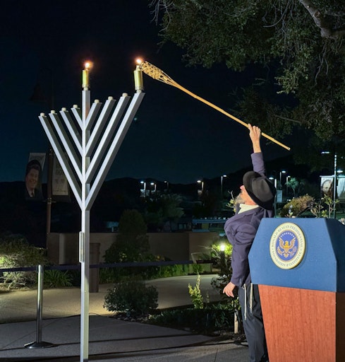 Person lighting the Menorah