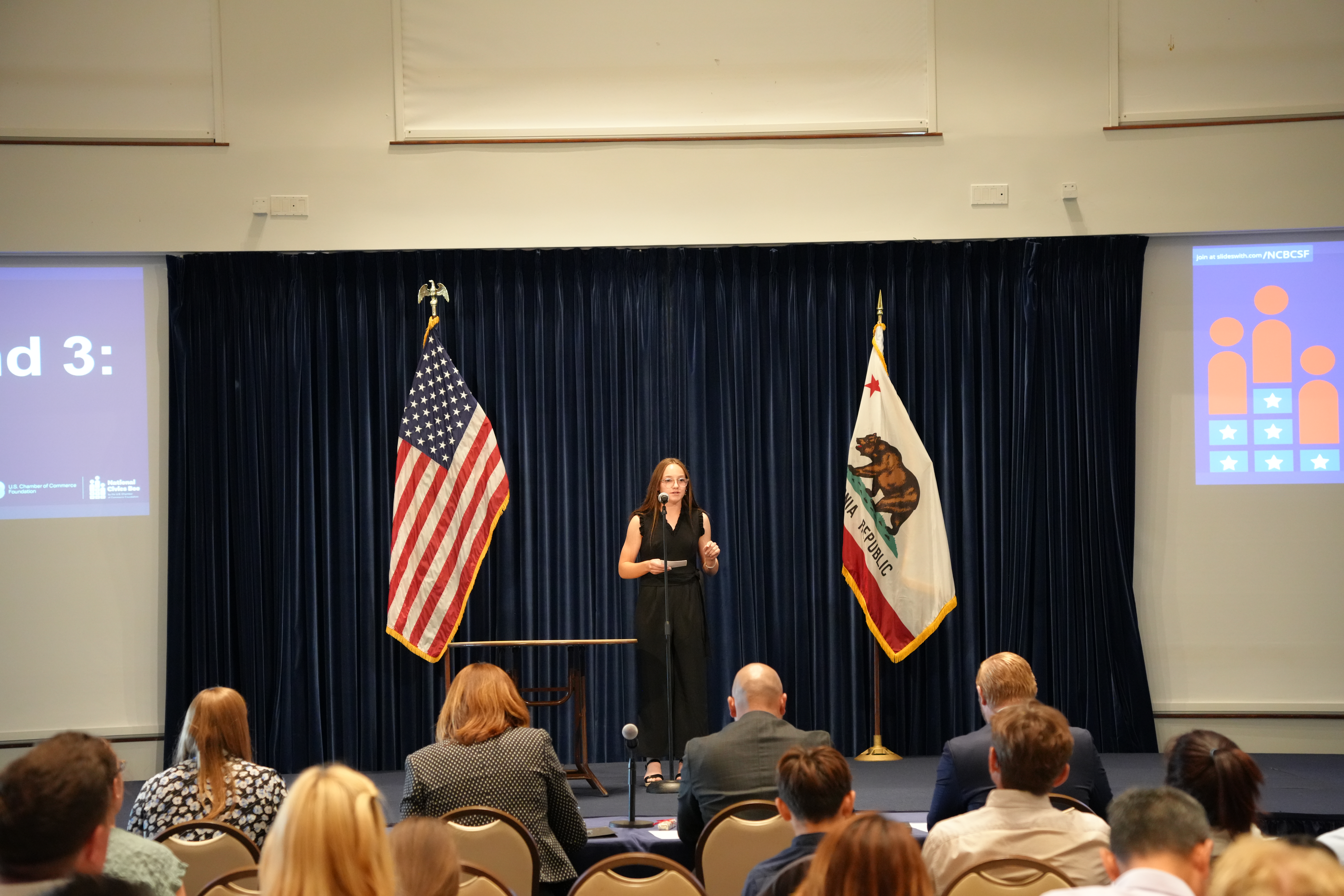 Female Student Speaking at Microphone