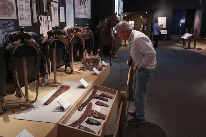 Guests looking at the exhibit pieces