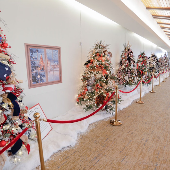 Walk Through Time: Christmas Trees That Tell America’s Story Row of Christmas Tree along the Colonnade