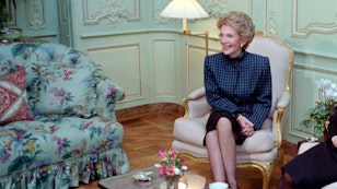 Mrs Reagan smiling and sitting with tea on the coffee table Mrs Reagan smiling and sitting with tea on the coffee table