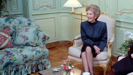 Mrs Reagan smiling and sitting with tea on the coffee table Mrs Reagan smiling and sitting with tea on the coffee table