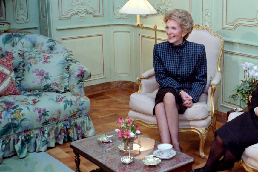 Mrs Reagan smiling and sitting with tea on the coffee table Mrs Reagan smiling and sitting with tea on the coffee table