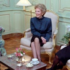 Mrs Reagan smiling and sitting with tea on the coffee table Mrs Reagan smiling and sitting with tea on the coffee table
