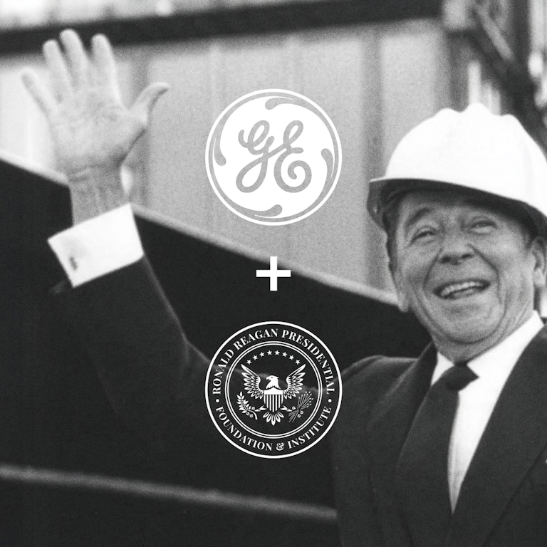 Ronald Reagan smiling and waving in a hard hat