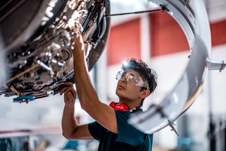 Young man working on a plane