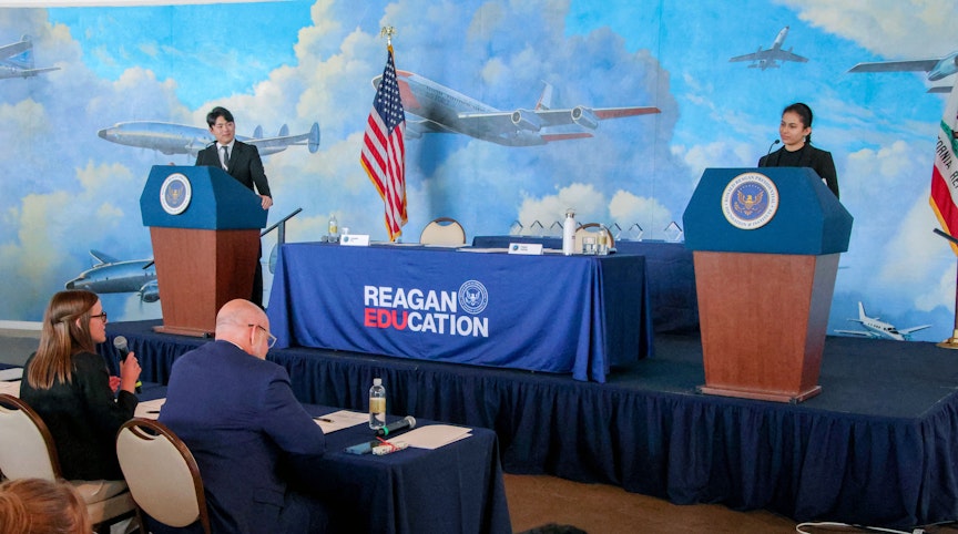2 students, each on a podium for the debate
