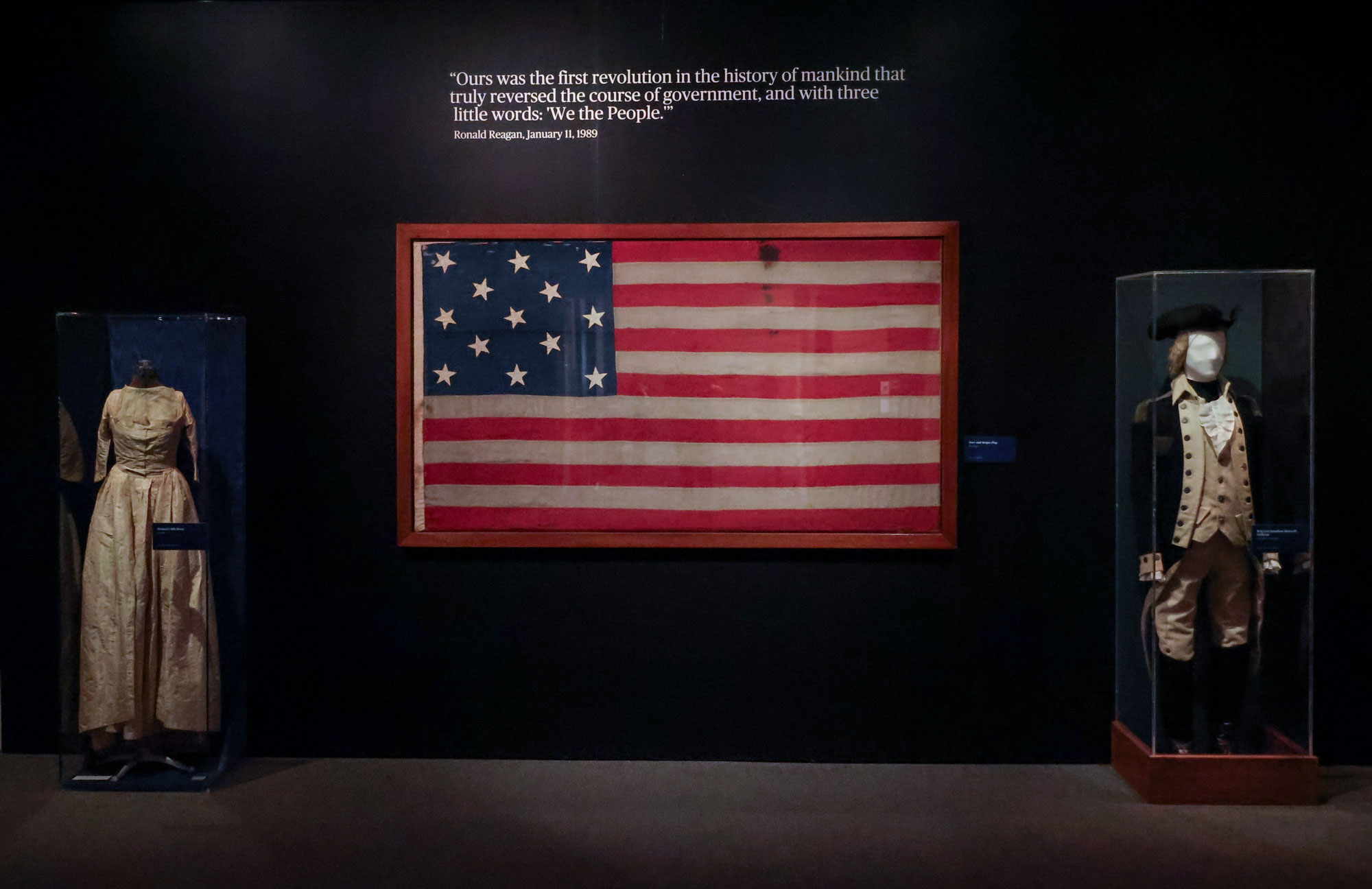 An authentic 18th-century American flag is paired with the original Revolutionary War uniform of Brigadier General Jonathon Bancroft