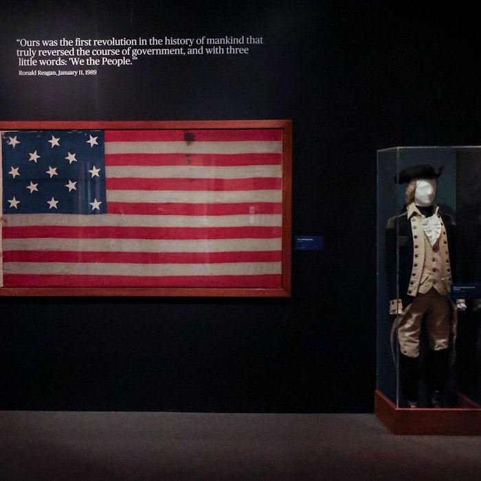 An authentic 18th-century American flag is paired with the original Revolutionary War uniform of Brigadier General Jonathon Bancroft An authentic 18th-century American flag is paired with the original Revolutionary War uniform of Brigadier General Jonathon Bancroft