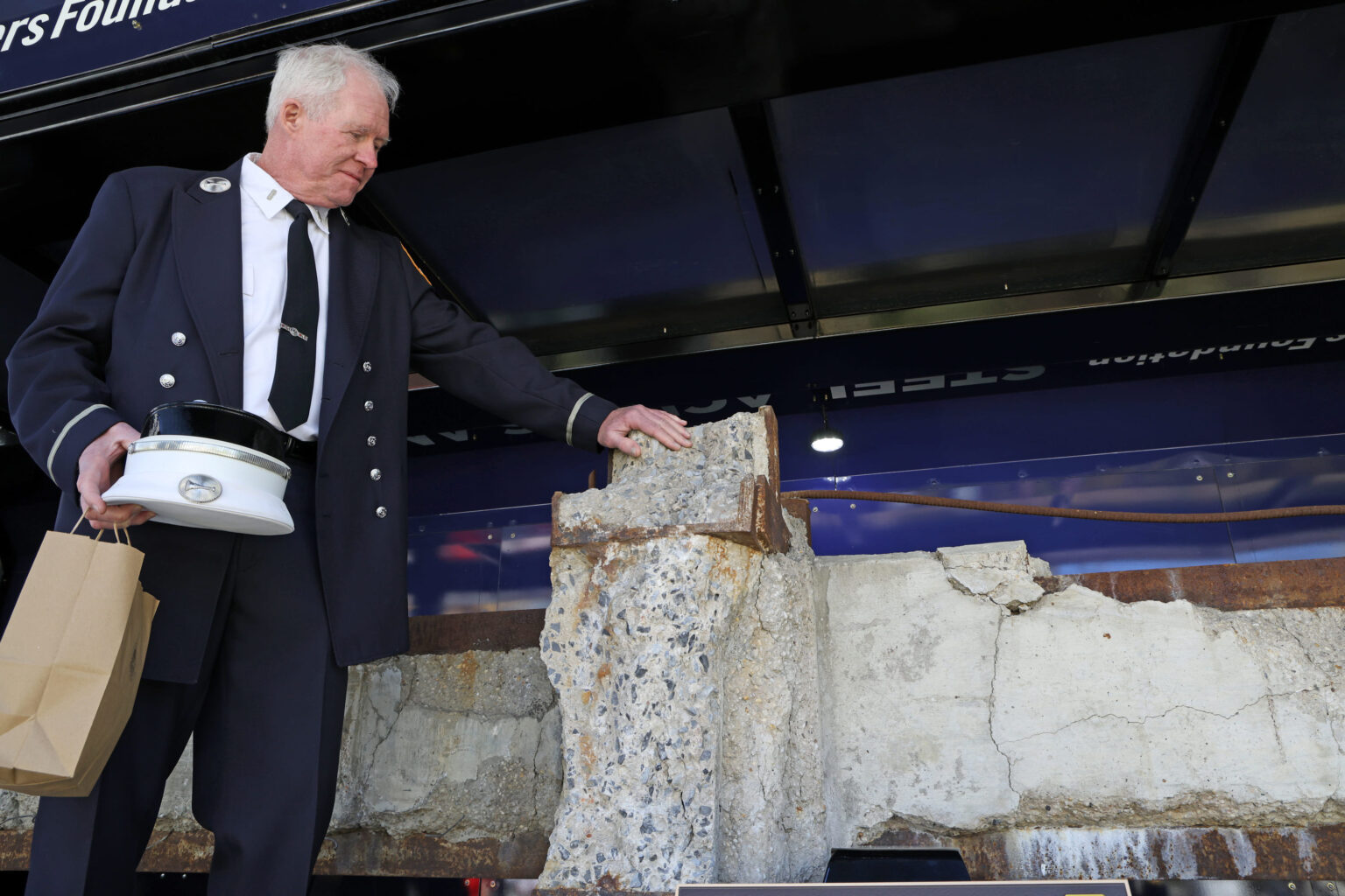 Person touching a steel beam recovered from the original World Trade Center