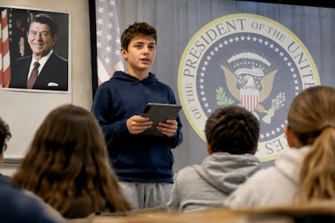 Student speaking in front of classroom