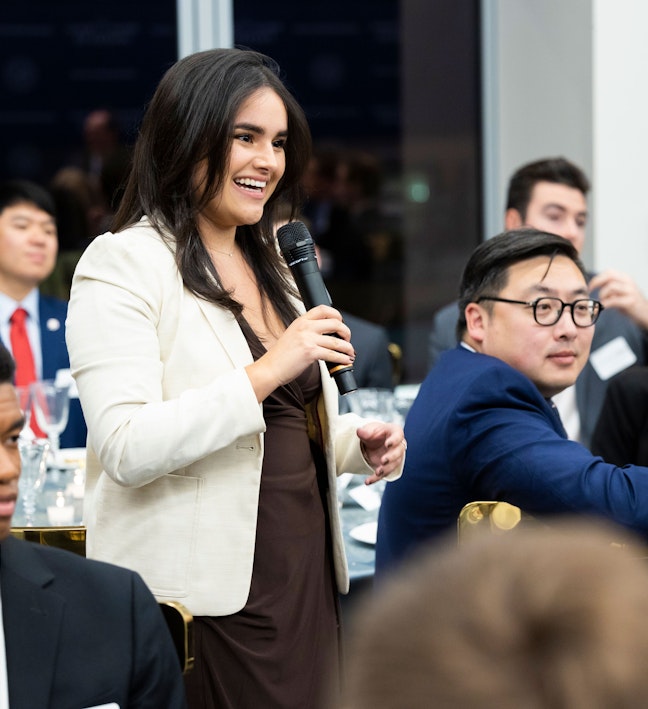 Student asking a question at an event. Student asking a question at an event.