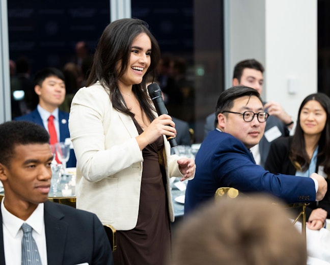 Student asking a question at an event.