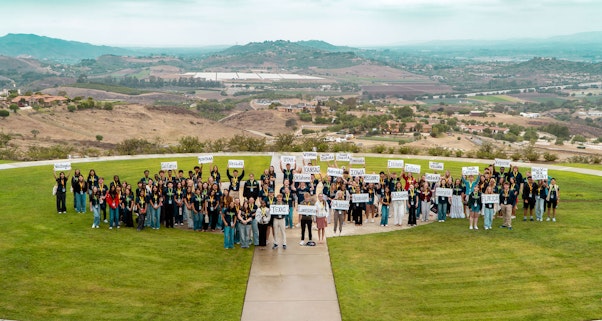 Students hold out name of the US States, outside at the Reagan Library South Lawn