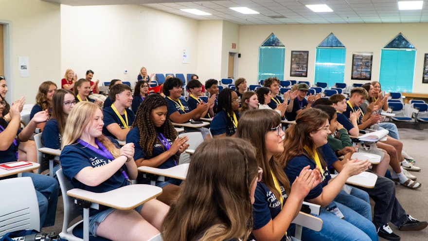 students clapping in classroom