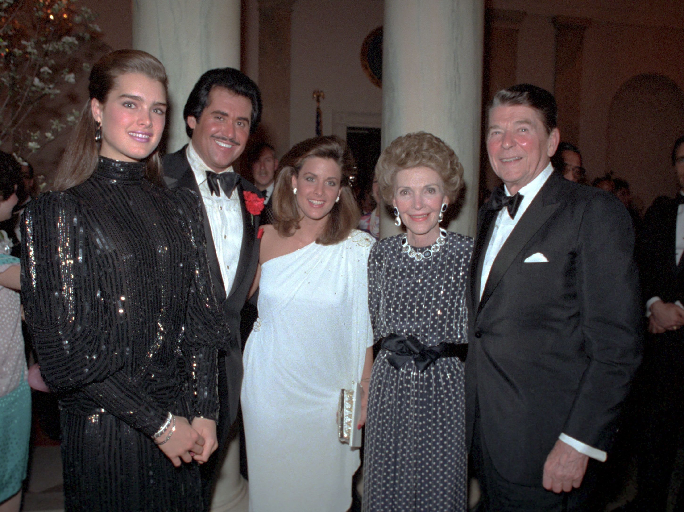 4/10/1984 President and Nancy Reagan with Brooke Shields Wayne Newton and Kathleen McCrone at a state dinner for President Jorge Blanco of Dominican Republic in entrance hall