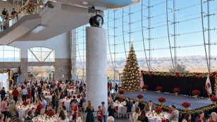 Guests enjoying a festive luncheon accompanied by live holiday music in a relaxed holiday setting