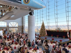 Guests enjoying a festive luncheon accompanied by live holiday music in a relaxed holiday setting