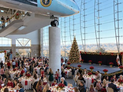 Guests enjoying a festive luncheon accompanied by live holiday music in a relaxed holiday setting