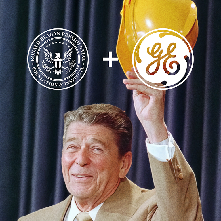 Ronald Reagan smiling and waving in a hard hat